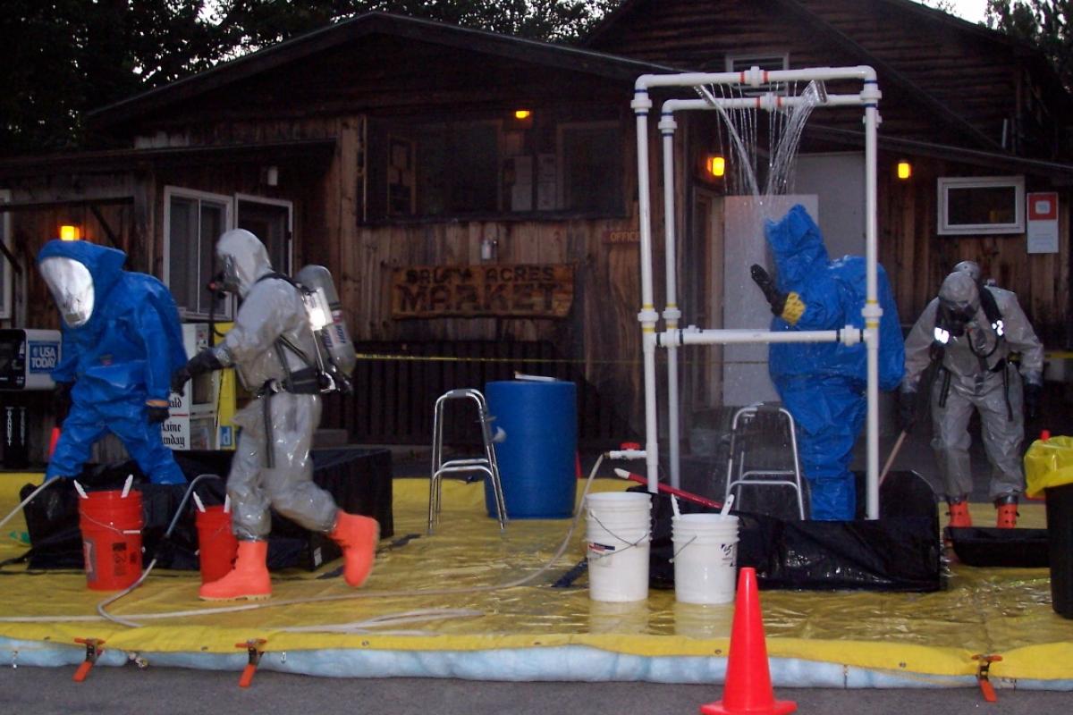July 2005: Kennebunkport Firefighters decontaminate members of the York County HAZMAT Team following an incident at a local campground.