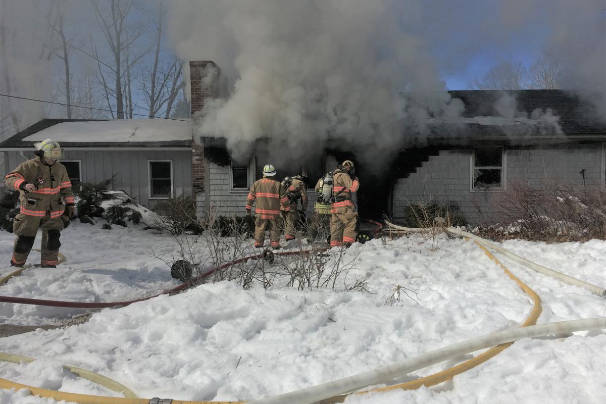 March 2017 Firefighters from Kennebunkport, Kennebunk & Arundel make entry during a structure fire on Wildes District Road.